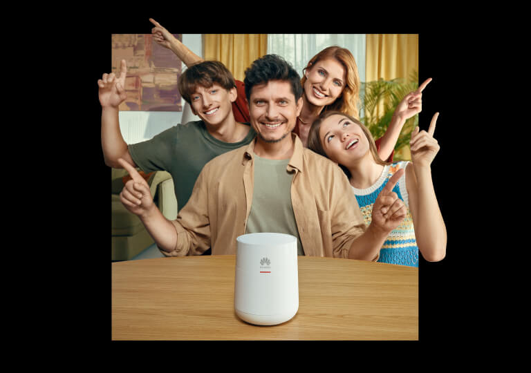 veselá rodina za stolom s prístrojom Huawei WiFi Mesh