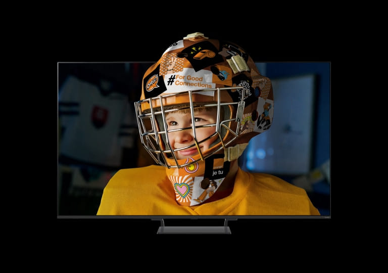 televízor LG QNED zobrazujúci dieťa v hokejovej prilbe